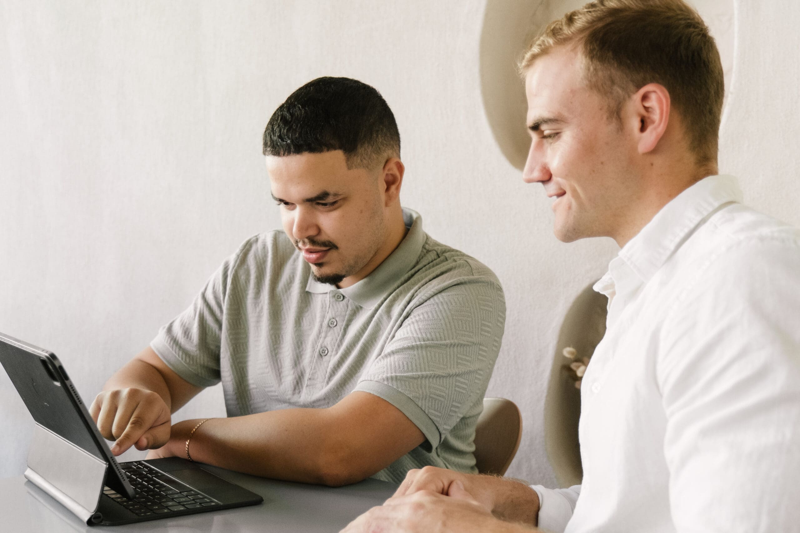 Two Don Creative Group team members reviewing work together on a tablet
