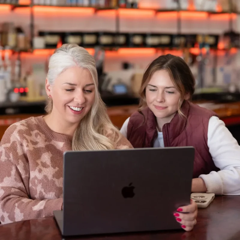 Marketing specialists speaking to happy clients on a conference call about success they achieved on a new marketing stratefy they implemented.