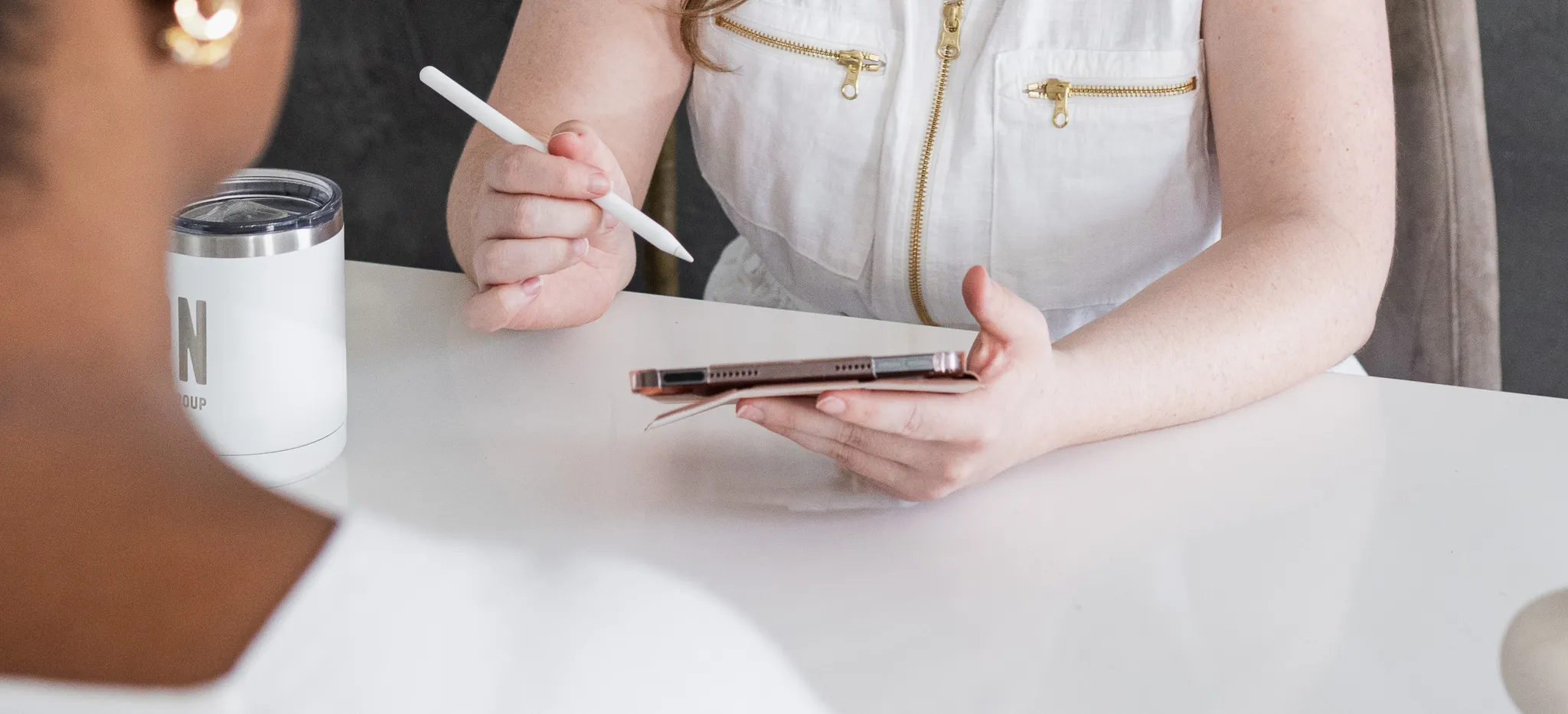 Creative team member presenting ideas on a tablet during a collaborative planning meeting