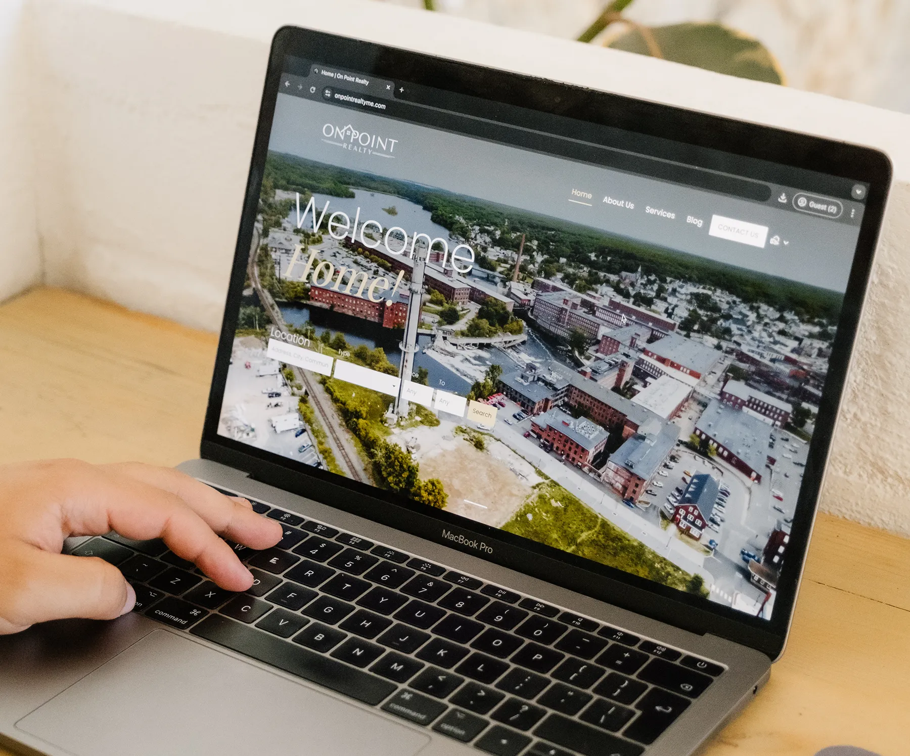 Close-up of a laptop displaying a custom website homepage during web design and development work.